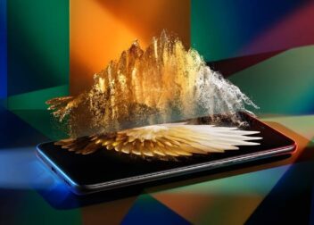 A futuristic smartphone display showing vibrant golden particles and a high-resolution wallpaper, representing the Tecno Spark 50 Pro screen quality.