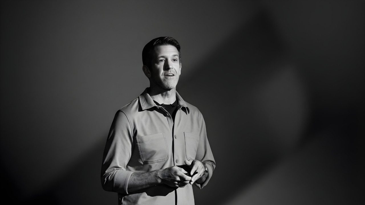 Apple's incoming CEO John Ternus speaking during a black and white hardware presentation event.