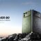 Rugged and durable itel Power 80 smartphone standing on coastal rocks
